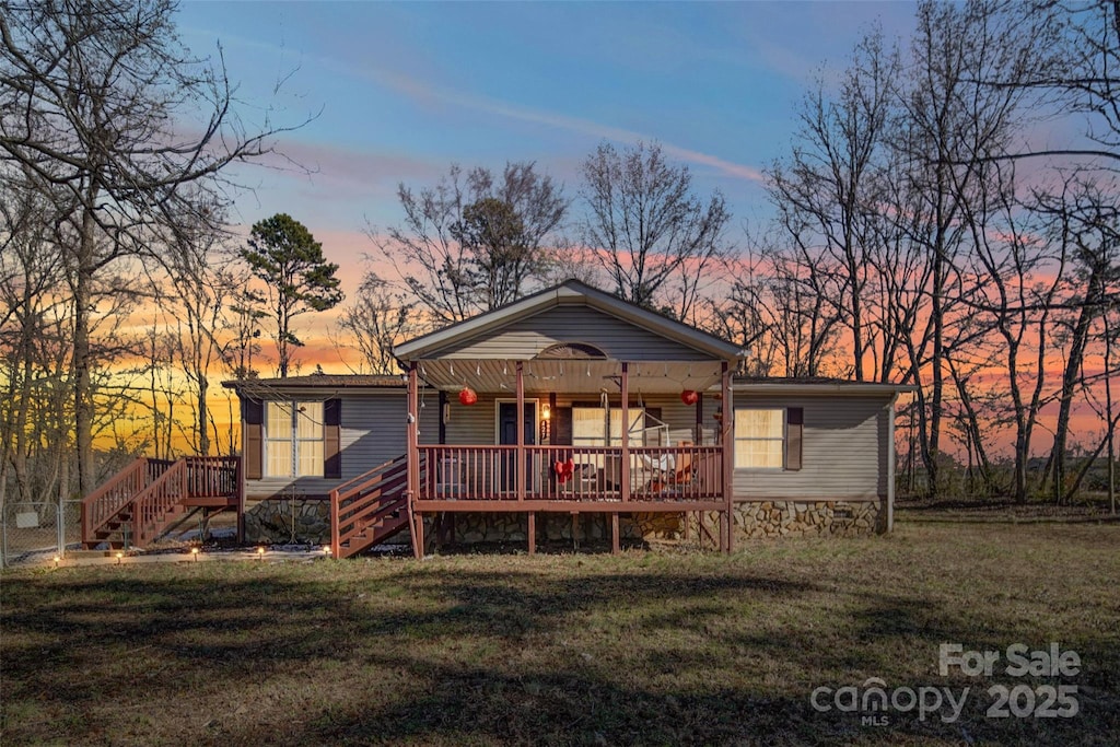 view of front facade featuring a yard and a deck