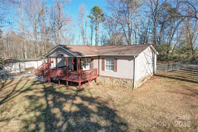 view of front of house featuring a front yard and a wooden deck