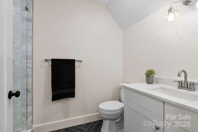 bathroom featuring toilet, vanity, tile patterned flooring, vaulted ceiling, and a shower with door