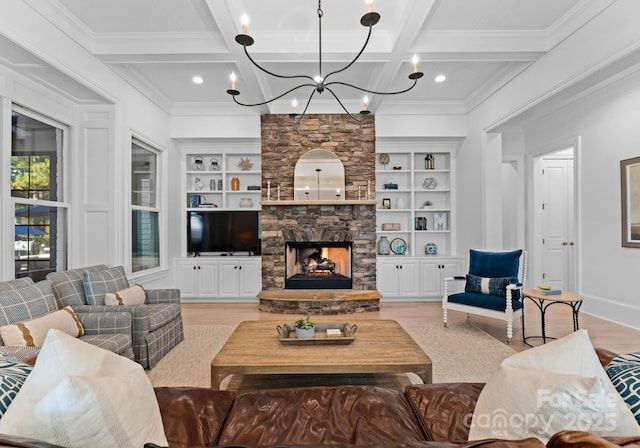 living room with a fireplace, light hardwood / wood-style flooring, coffered ceiling, built in shelves, and beam ceiling