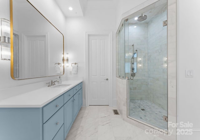 bathroom with vanity and a shower with shower door