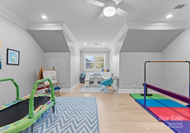 recreation room with ceiling fan, light hardwood / wood-style flooring, and ornamental molding