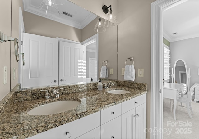 bathroom featuring crown molding and vanity