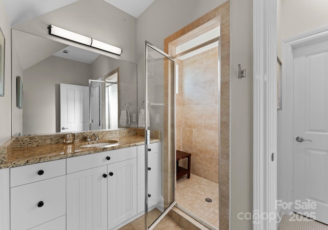 bathroom with walk in shower and vanity