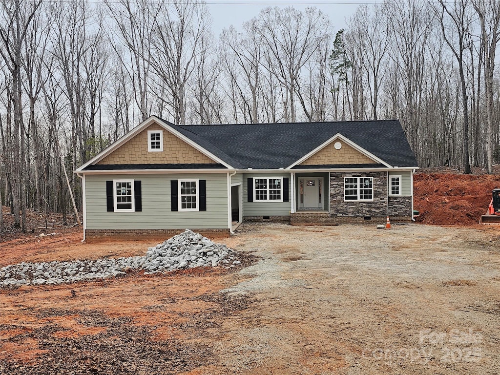 view of front of home featuring crawl space and stone siding