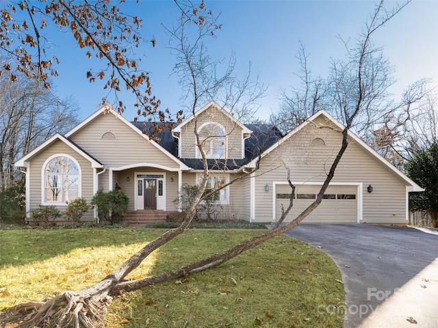 front of property with a front yard and a garage