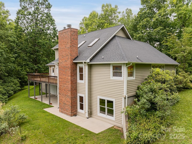 15 Breckenridge Dr, Fairview, NC 28730 - back of property featuring a patio area, a chimney, roof with shingles, a yard, and a deck