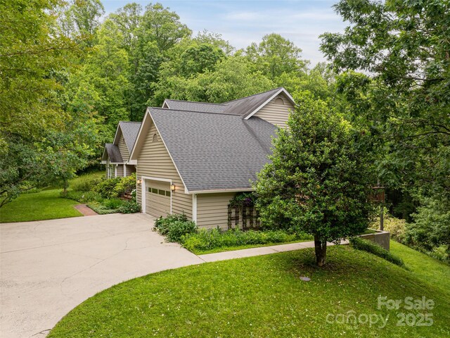 15 Breckenridge Dr, Fairview, NC 28730 - view of front facade featuring a shingled roof, concrete driveway, an attached garage, and a front lawn