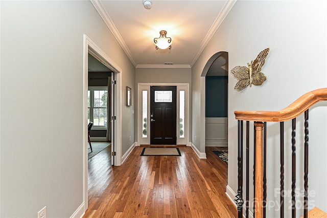 entrance foyer featuring hardwood / wood-style floors and crown molding