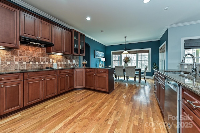 kitchen featuring sink, dark stone countertops, hanging light fixtures, stainless steel dishwasher, and black electric cooktop