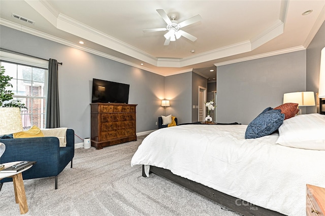 bedroom featuring ceiling fan, light colored carpet, ornamental molding, and a raised ceiling