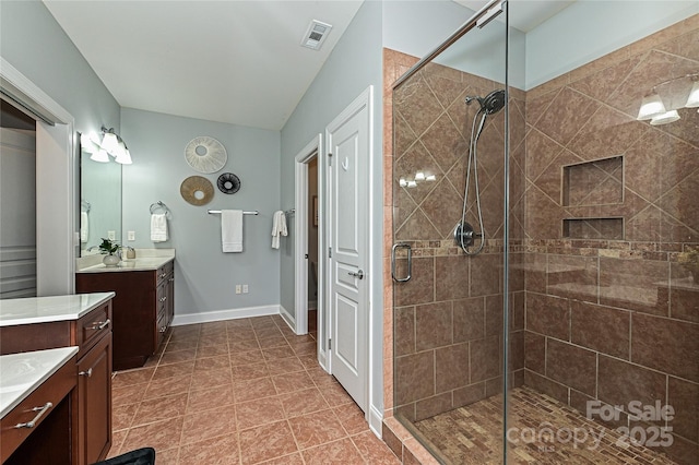 bathroom with tile patterned floors, vanity, and an enclosed shower