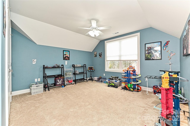 game room with ceiling fan, lofted ceiling, and light carpet