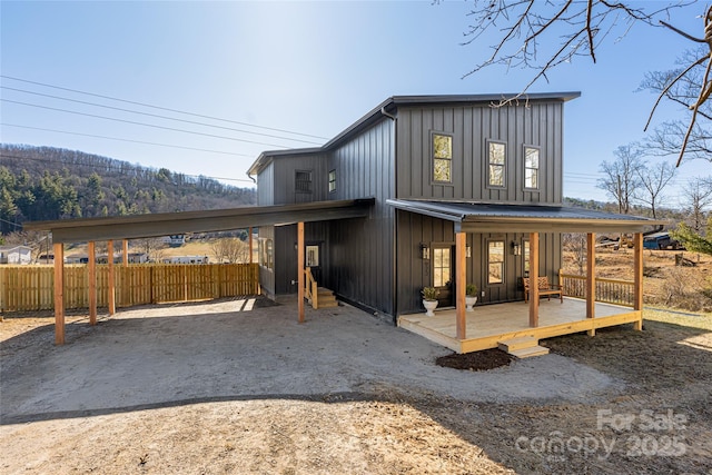 exterior space with a carport and covered porch