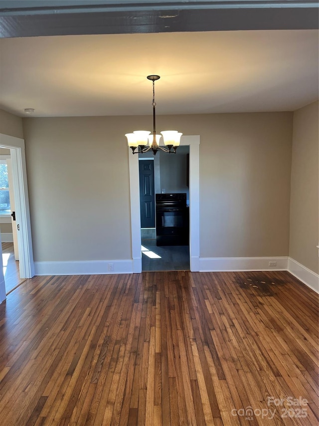 unfurnished dining area featuring a notable chandelier and dark hardwood / wood-style floors