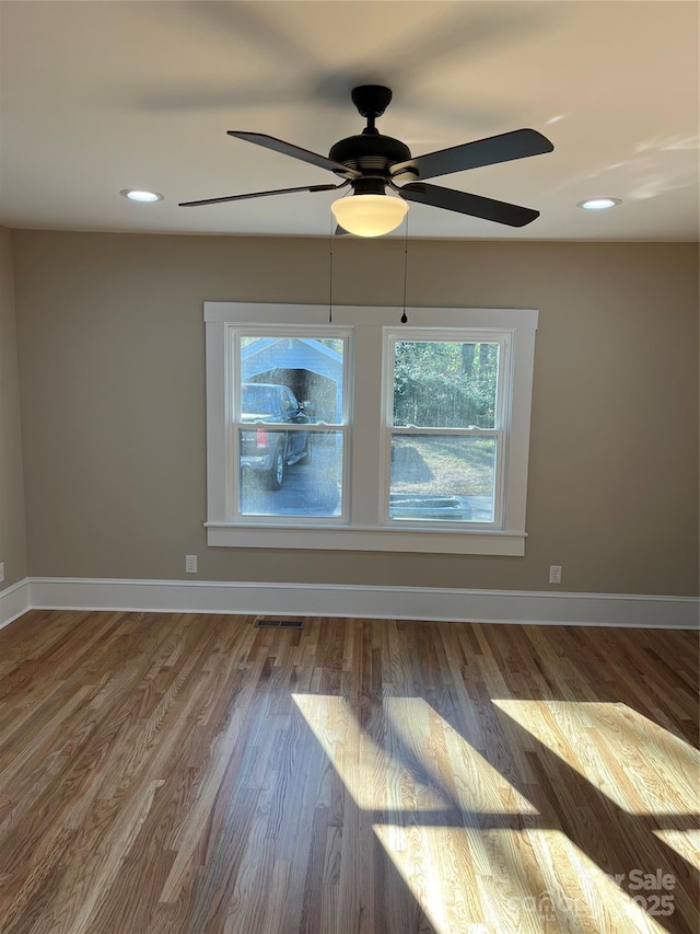 empty room featuring ceiling fan and hardwood / wood-style flooring