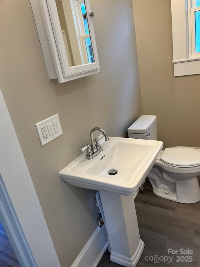 bathroom with toilet and wood-type flooring