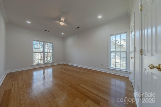 spare room featuring ceiling fan, a healthy amount of sunlight, light hardwood / wood-style floors, and crown molding