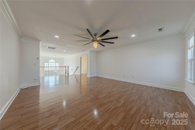 unfurnished room featuring ceiling fan, hardwood / wood-style floors, and ornamental molding