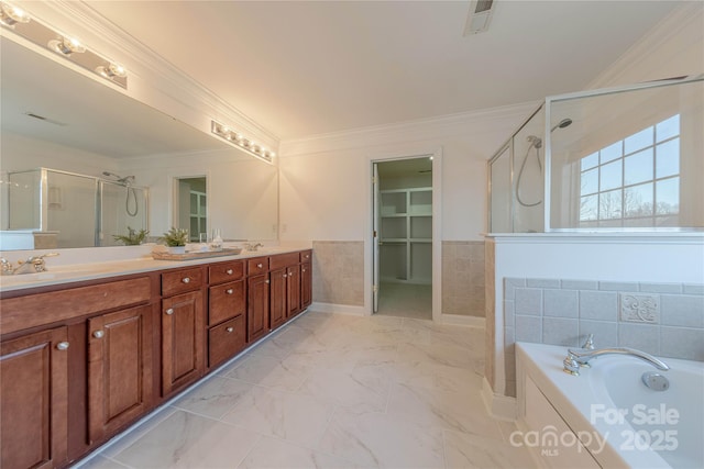 bathroom with ornamental molding, separate shower and tub, and vanity