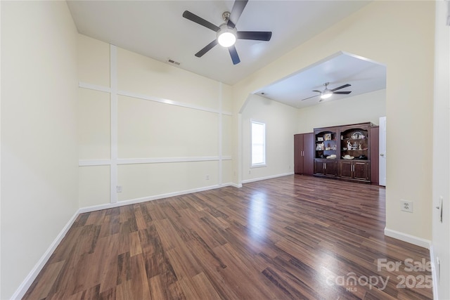 unfurnished living room with ceiling fan and dark hardwood / wood-style flooring