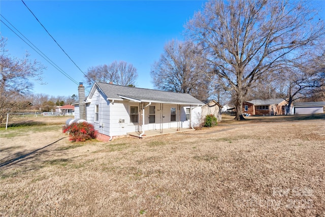 exterior space with covered porch and a front lawn