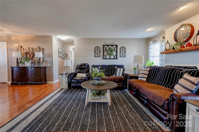 living room with hardwood / wood-style floors and a textured ceiling