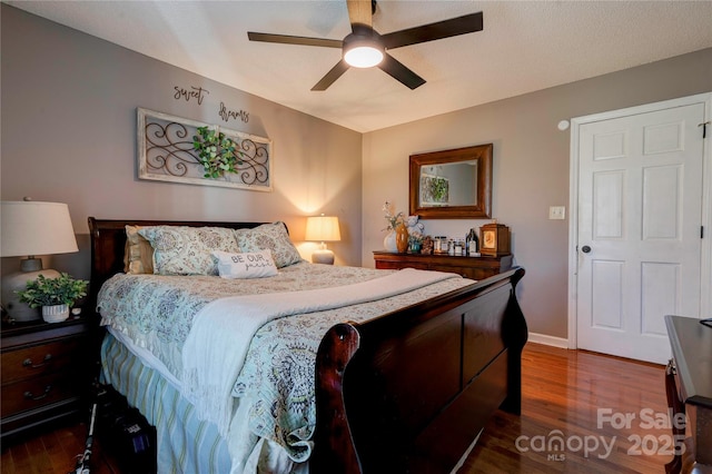 bedroom with dark wood-type flooring and ceiling fan