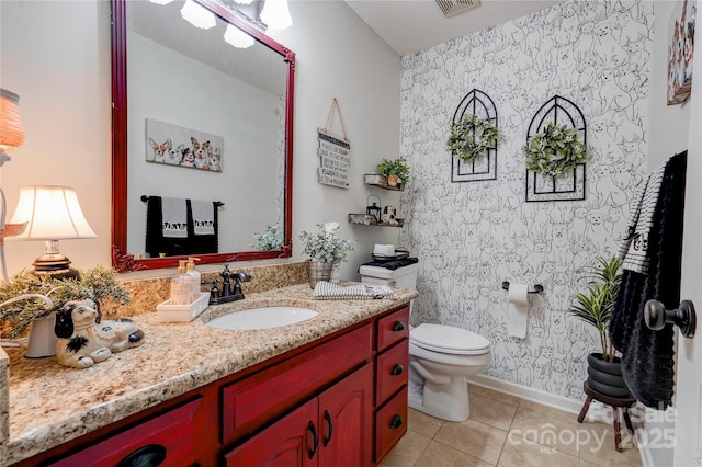 bathroom with vanity, toilet, tile patterned flooring, and a textured ceiling