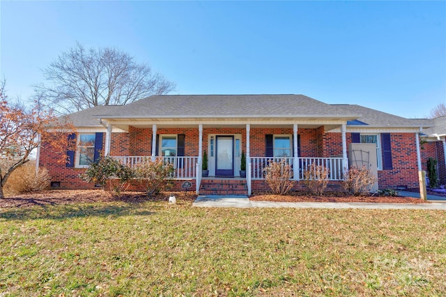 ranch-style home featuring covered porch and a front lawn