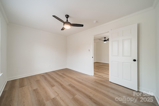 spare room featuring ornamental molding, ceiling fan, and light wood-type flooring