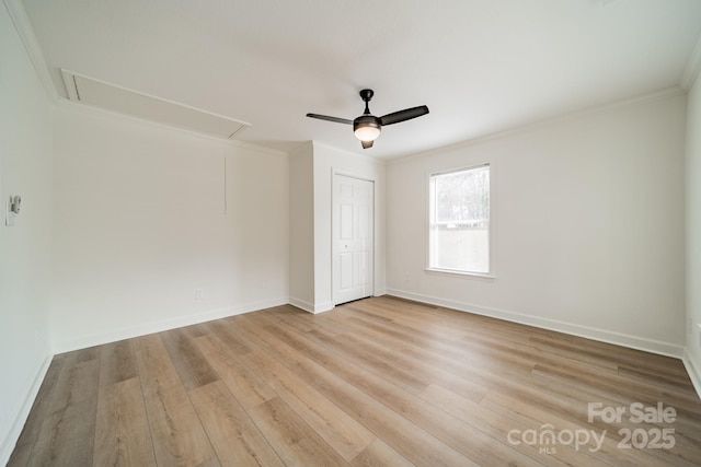 spare room featuring ornamental molding, ceiling fan, and light wood-type flooring