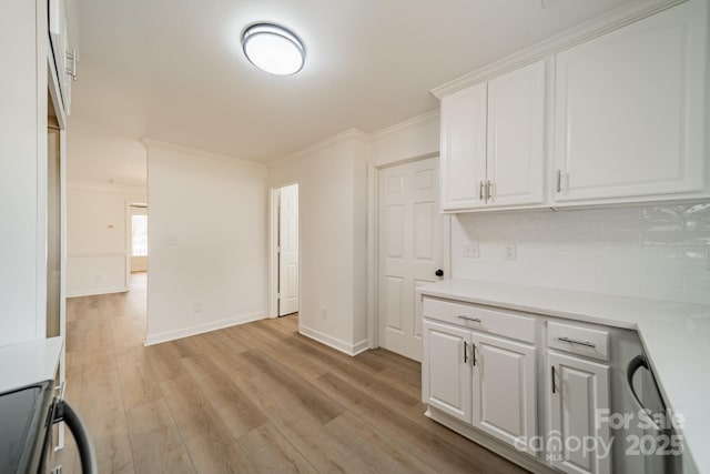 kitchen with crown molding, tasteful backsplash, light hardwood / wood-style floors, white cabinets, and stainless steel range with electric cooktop