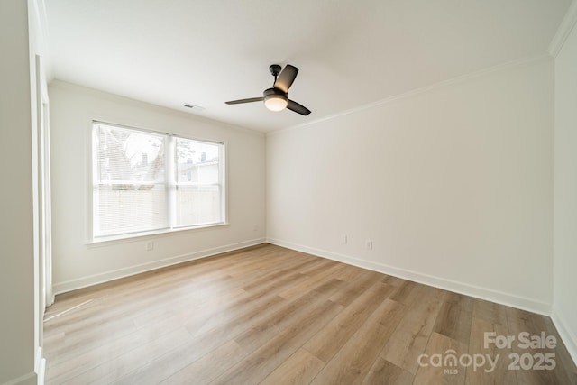 empty room featuring crown molding, ceiling fan, and light hardwood / wood-style floors