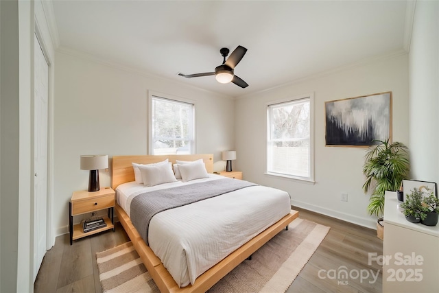 bedroom featuring hardwood / wood-style floors, crown molding, a closet, and ceiling fan