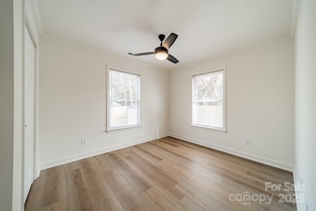 unfurnished room featuring crown molding, ceiling fan, and light wood-type flooring