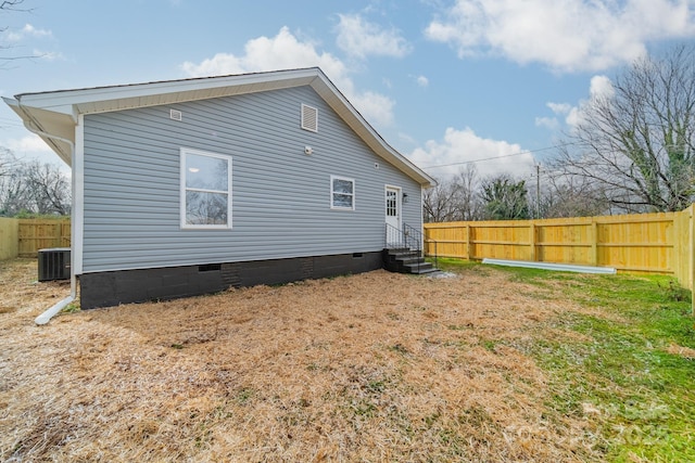 rear view of property featuring cooling unit and a yard