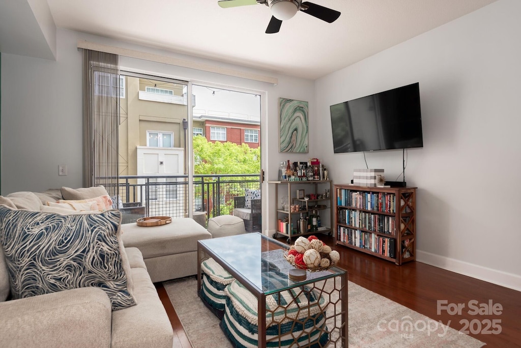 living room with ceiling fan and hardwood / wood-style flooring