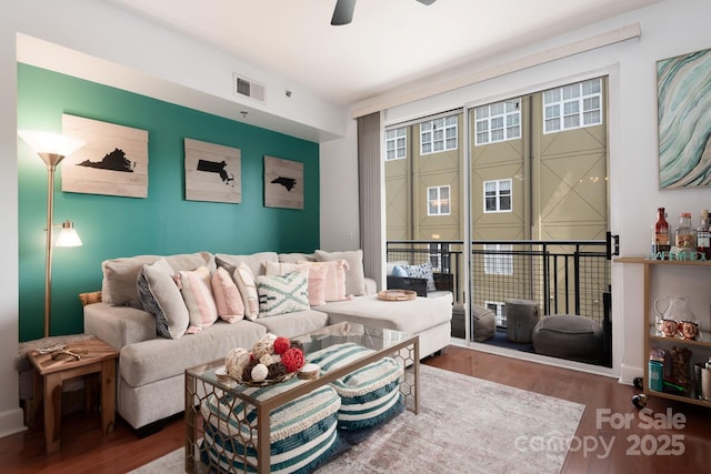 living room with ceiling fan and hardwood / wood-style flooring