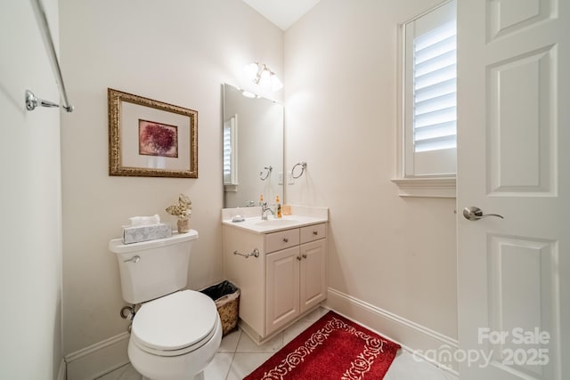 bathroom with vanity, tile patterned flooring, and toilet