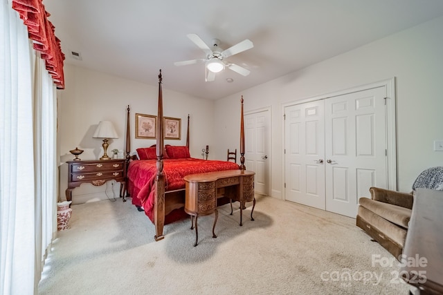 bedroom with ceiling fan and light carpet