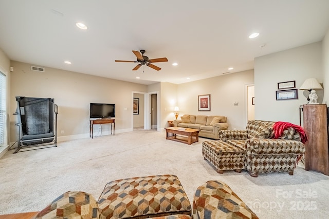 carpeted living room featuring ceiling fan