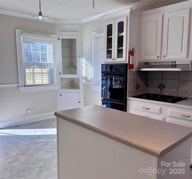 kitchen with a textured ceiling, white cabinets, black appliances, decorative backsplash, and ornamental molding