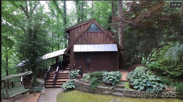 view of outbuilding with a view of trees