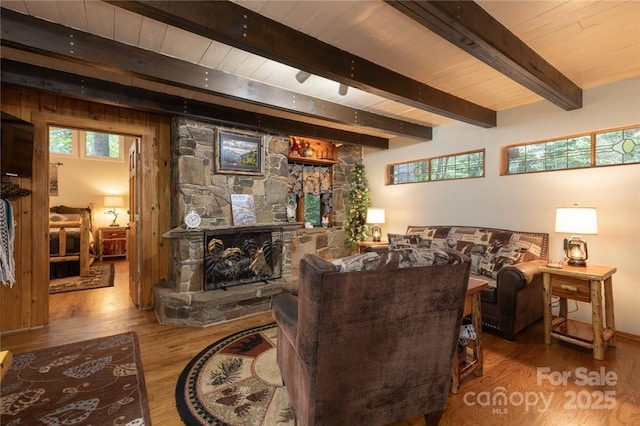 living room with wood ceiling, a fireplace, wood finished floors, and beamed ceiling