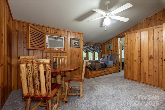 bedroom with wood walls, carpet, vaulted ceiling, and an AC wall unit