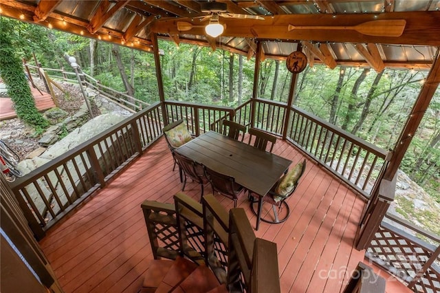 wooden terrace featuring outdoor dining area