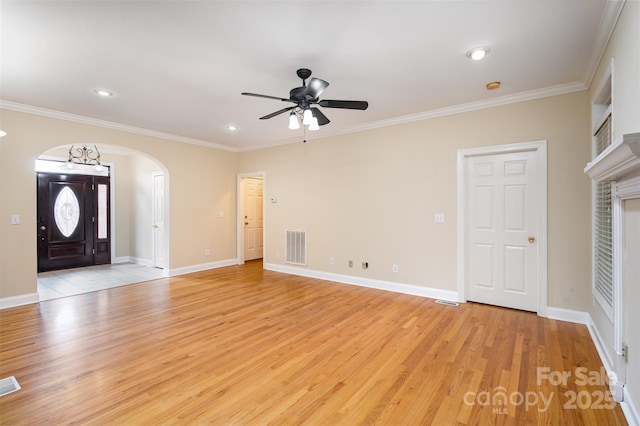 entrance foyer featuring ceiling fan, ornamental molding, and light hardwood / wood-style floors