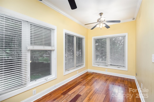 unfurnished sunroom featuring ceiling fan