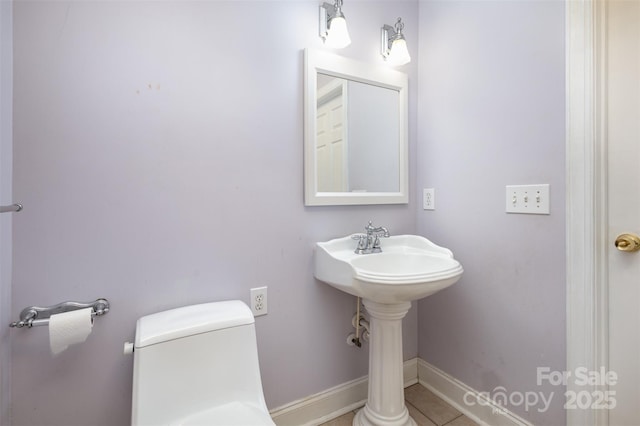 bathroom with tile patterned flooring and toilet